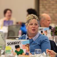 people talking at luncheon table